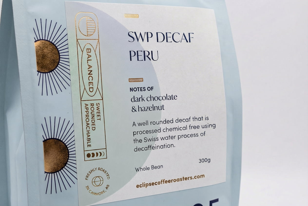 Eclipse Coffee Roasters SWP Decaf Peru whole bean coffee bag with Swiss Water Process, notes of dark chocolate and hazelnut, roasted in Canmore, Alberta.