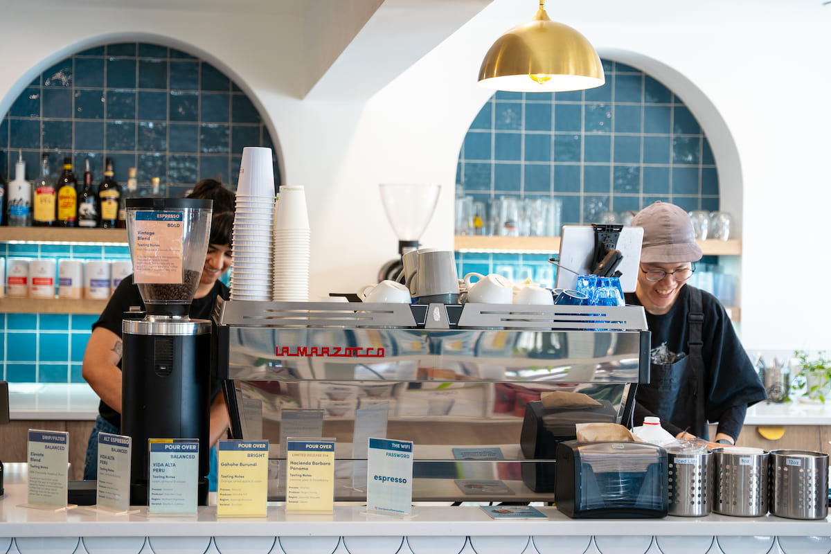 Baristas working behind the espresso bar at Eclipse Coffee Roasters on Railway Avenue in Canmore.