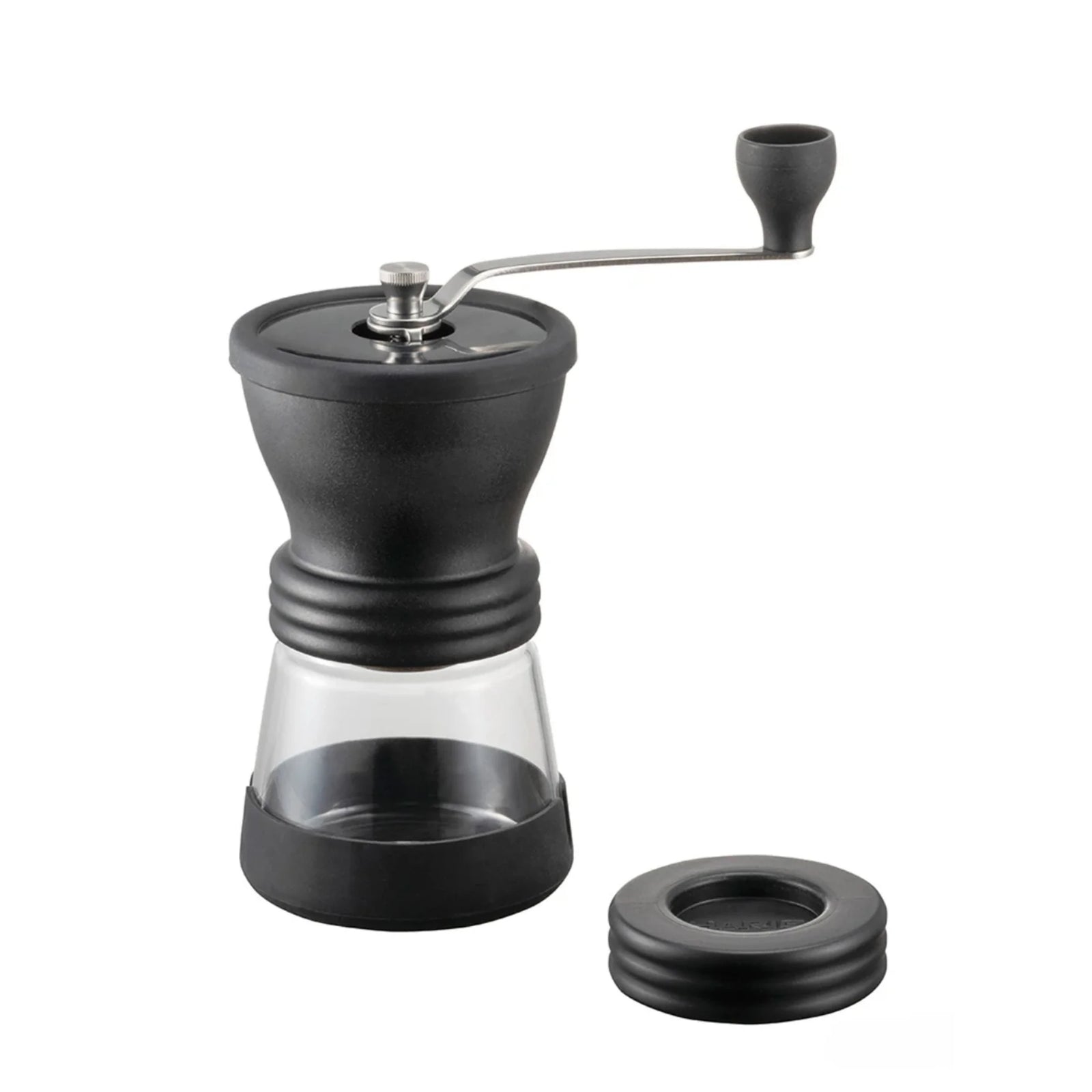 A black Hario Skerton Plus hand coffee grinder with a transparent container at the bottom and a metal crank on top.